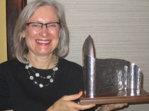 Dr. Laura Welch is honored for helping to keep workers in good medical condition.