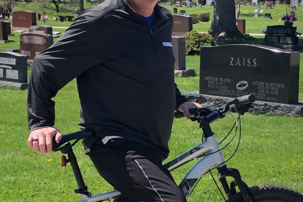 Charles Jon Garst standing with a bike