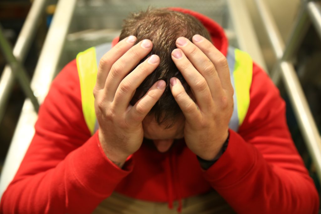 Man with head bent in his hands.