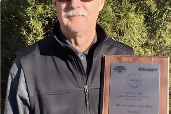 Photo of Mike McCullion holding an award