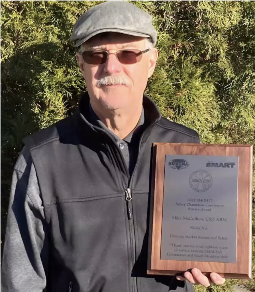 Photo of Mike McCullion holding an award