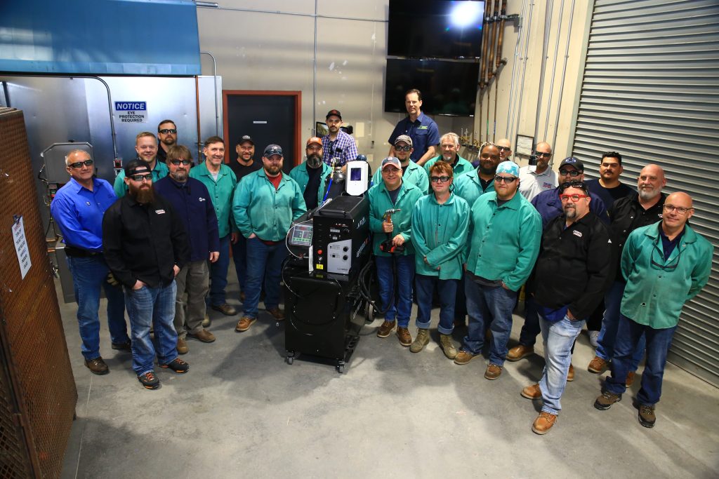 Attendees at the hand-held laser welder training standing together