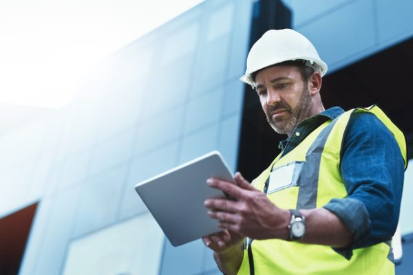 Shot of a engineer using a digital tablet on a construction site